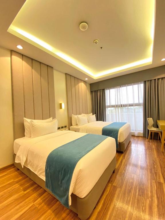 Postel nebo postele na pokoji v ubytování Bravo Tanauan Hotel