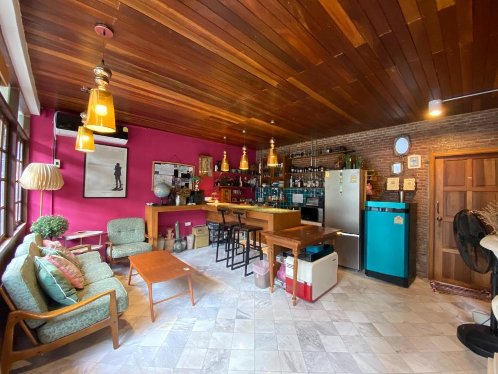 a living room with pink walls and a bar at T-House BKK 2Floors near BTS with swimming pool and free Wifi in Klong Toi