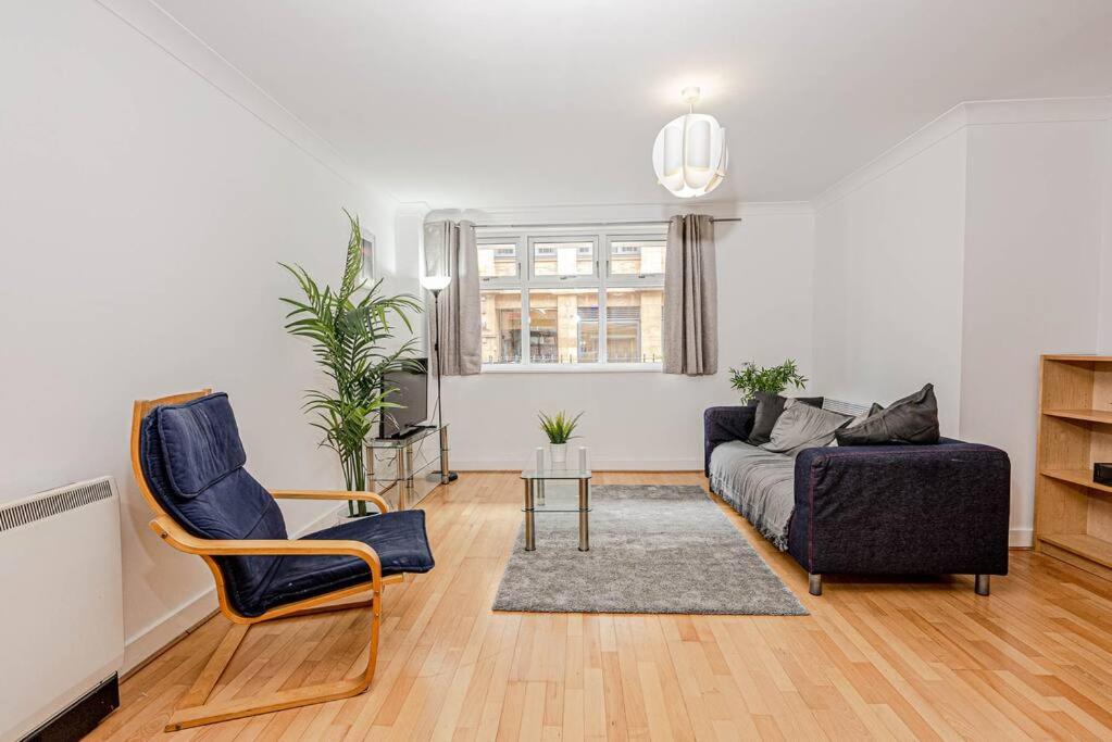 a living room with a couch and a chair at Luxury Modern 1 Bedroom Apartment In Birmingham City Centre-Free Parking in Birmingham