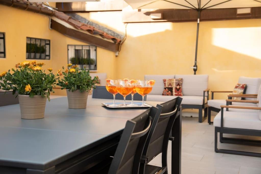 a table with two wine glasses on top of it at Casa del Carro 2 Grand Terrace Apartment in Venice