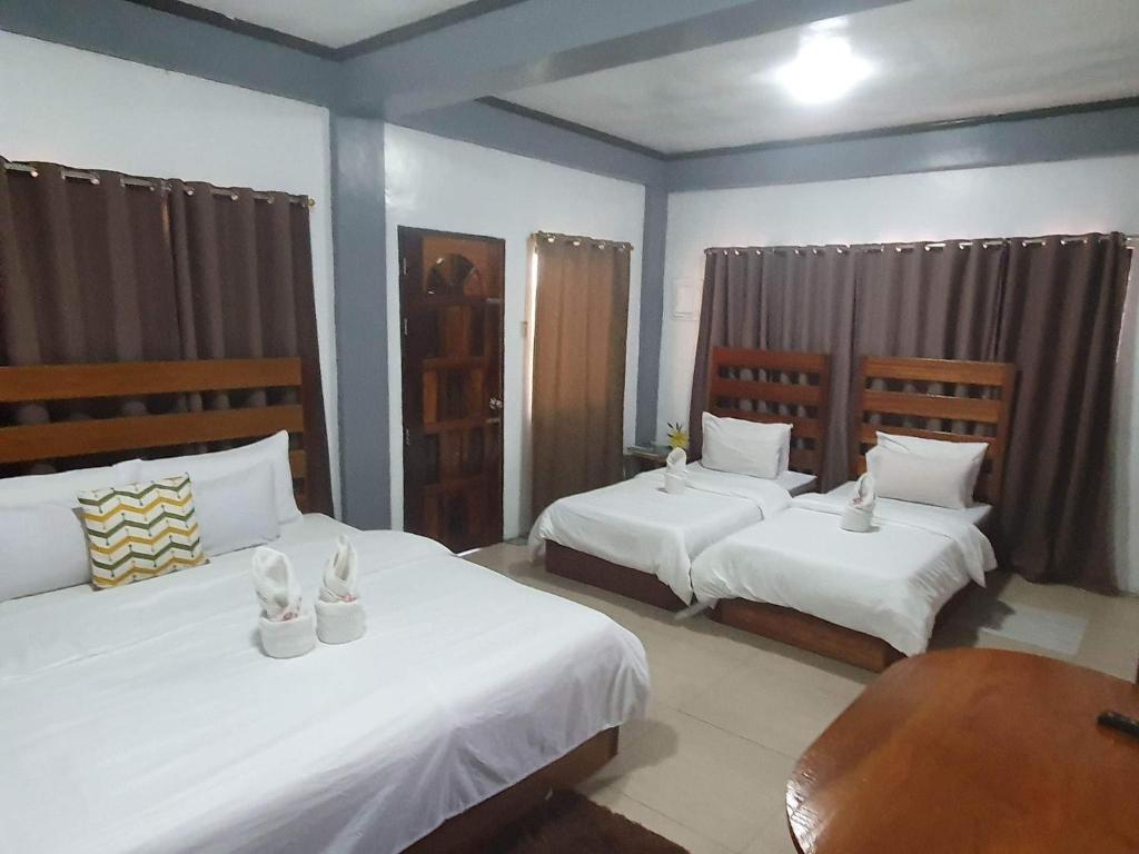 Postel nebo postele na pokoji v ubytování Kalis Viewpoint Lodge Coron