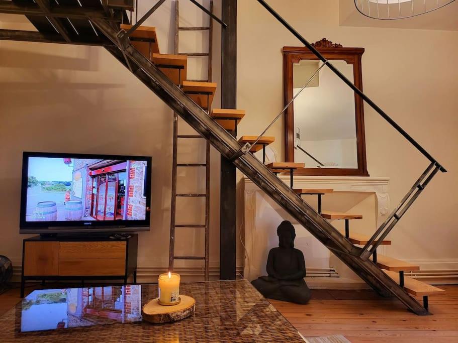 Televízia a/alebo spoločenská miestnosť v ubytovaní Duplex bohème chic
