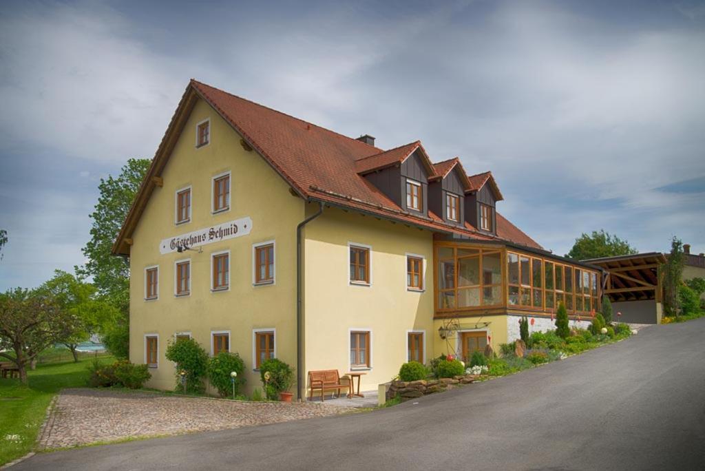 a large yellow building with a brown roof at Gästehaus Schmid Kondrau in Waldsassen