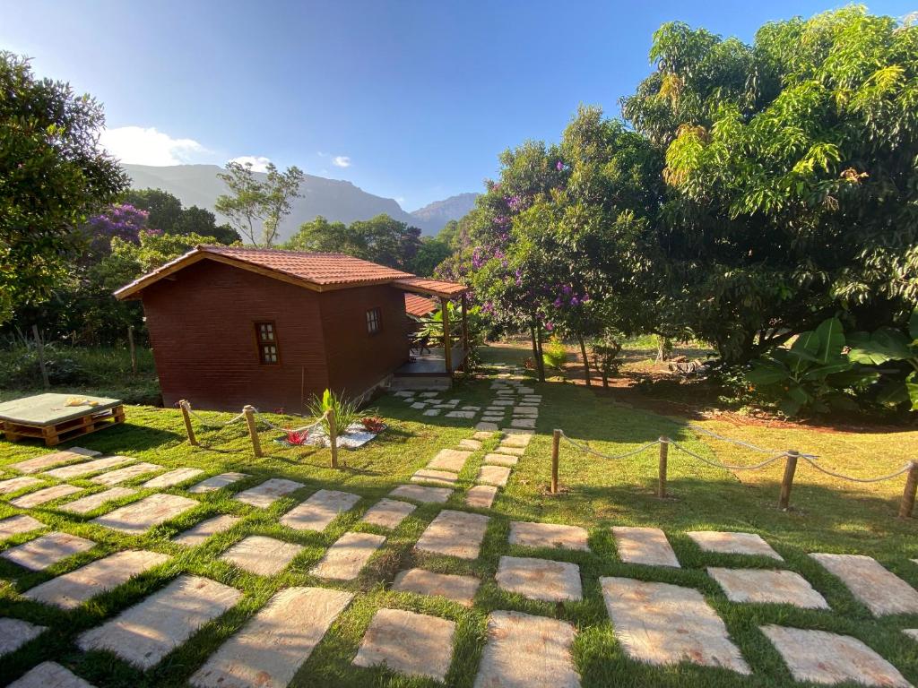 a small house in the middle of a yard at Chalés Vila Do Vale in Vale do Capao