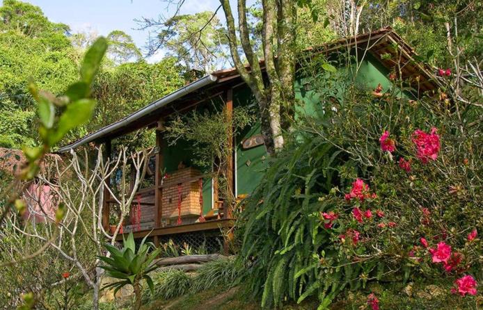 uma casa com flores em frente em Pousada Moriá em Viscode de Mauá