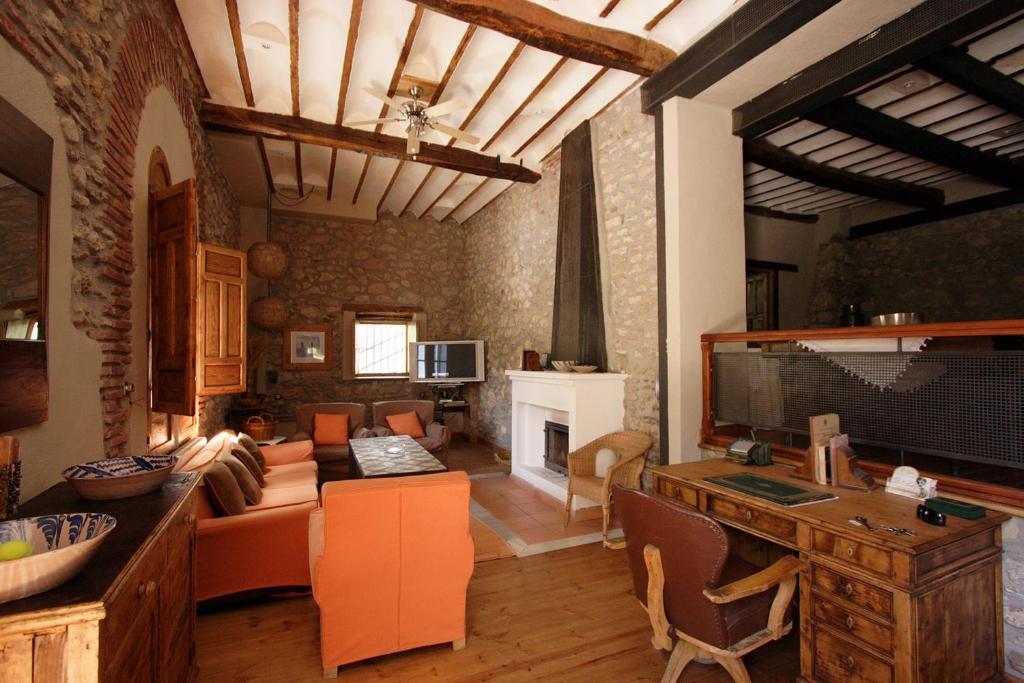 a living room with a couch and a fireplace at Cortijo Palacete La Tala in Guadix