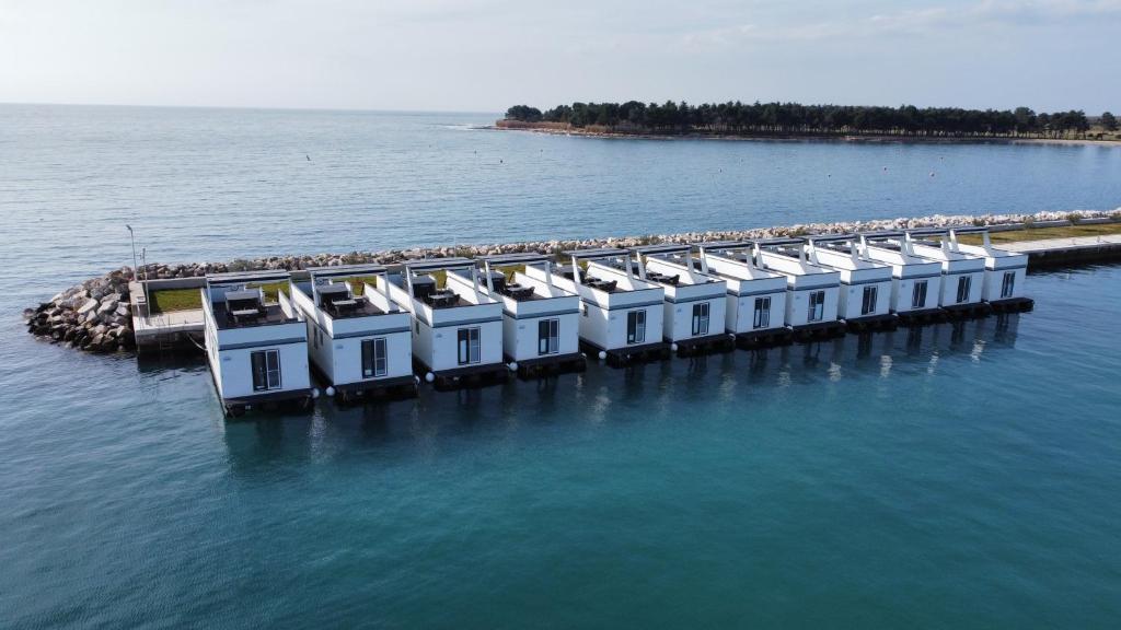 an aerial view of a dock in the water at The Sea Lodges Novigrad - Bootshaus Floating Sea House in Novigrad Istria