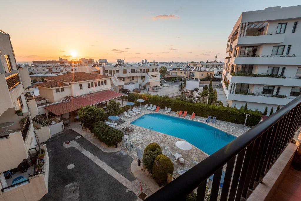 a view from the balcony of a building with a swimming pool at Alexis Apartments - Lovely 2-bedroom with swimming pool in Paphos City