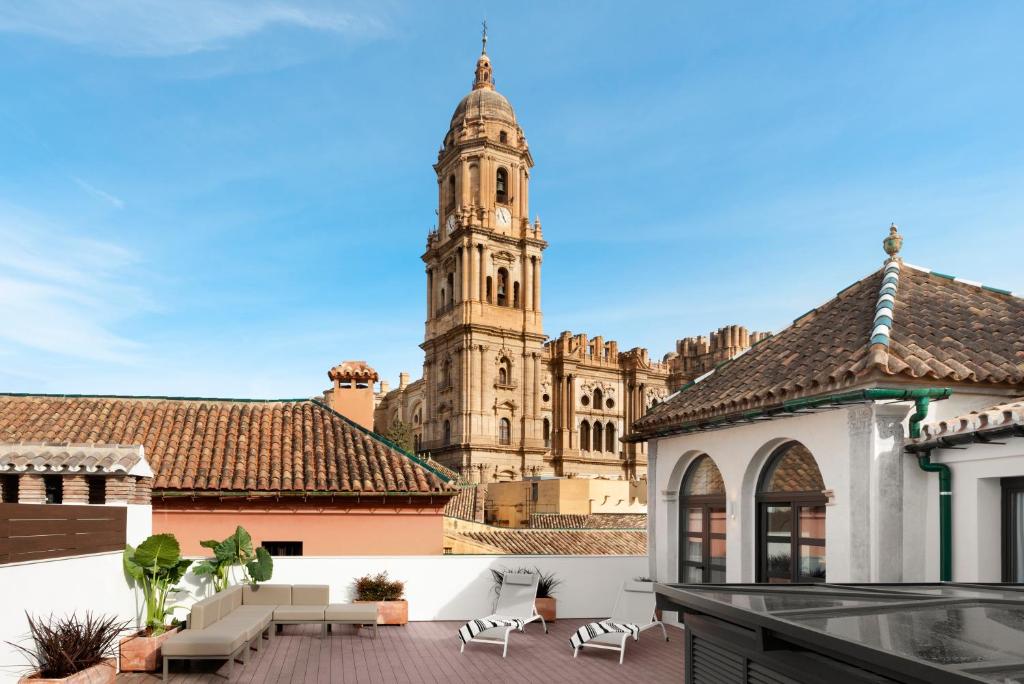 a view of a building with a clock tower at Coeo Apart-Hotel Fresca in Málaga