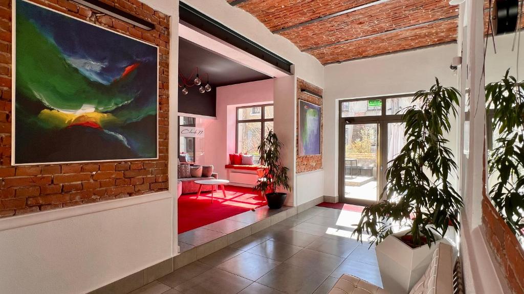 a hallway with a brick wall and a painting on the wall at Hotel77 in Zamość