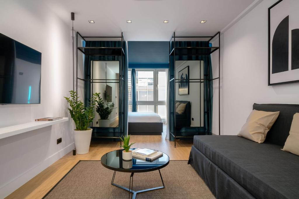 a living room with a couch and a table at Dion Luxury Suites in Athens