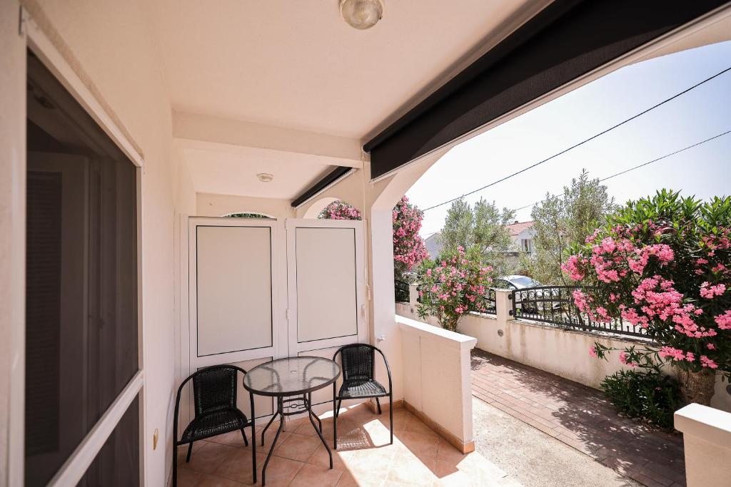 a balcony with a table and chairs on a balcony at Apartments Marina in Petrcane
