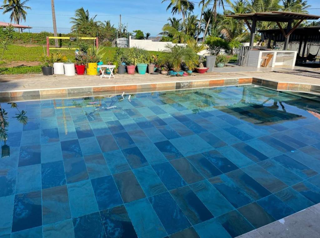 a swimming pool with blue tiles on the floor at Tampok lodge in Cayenne