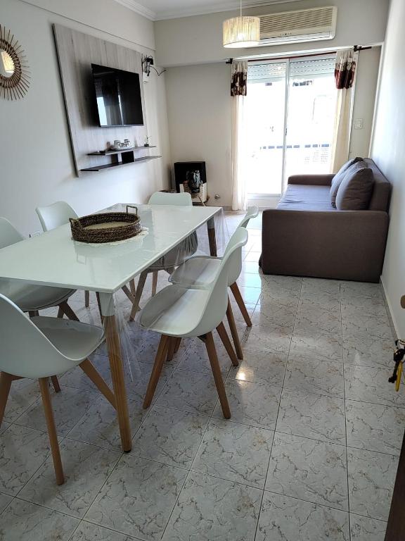 a living room with a table and chairs and a couch at Temporarios Roque Saenz Peña, Dto D in Puerto Madryn