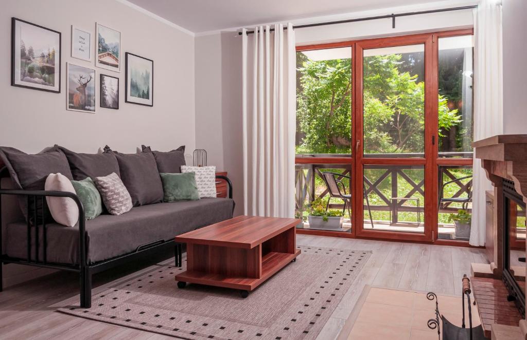 a living room with a couch and a table at Утро без Аларма, Смолянски езера. Alarm free Morning Smolyan lakes in Smolyan