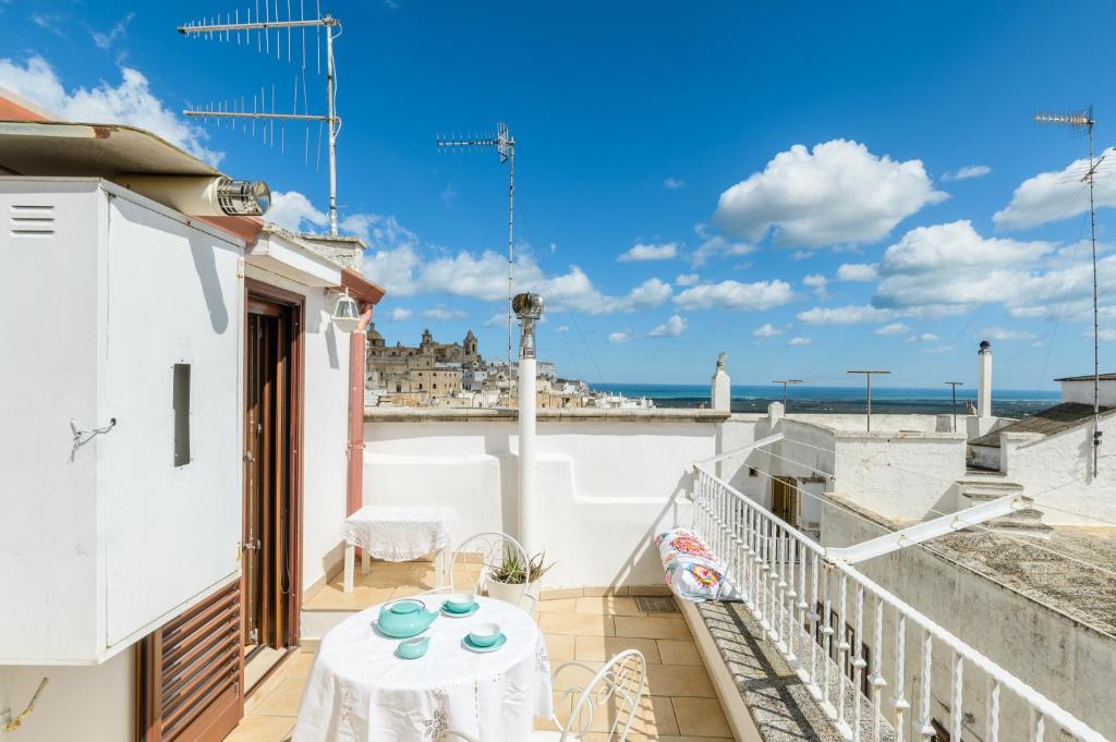 a balcony with a table and a view of the ocean at La Terrazza del Marinaio in Ostuni