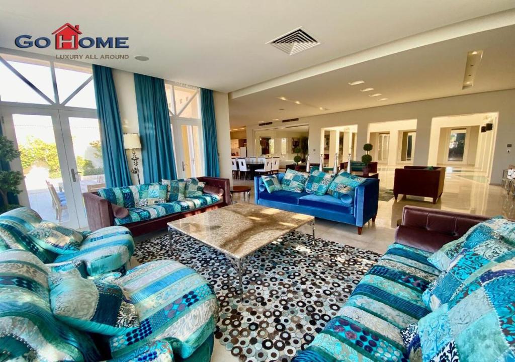 a large living room with blue couches and a living room at Stylish 5B Room MB04@ New Marina in Hurghada