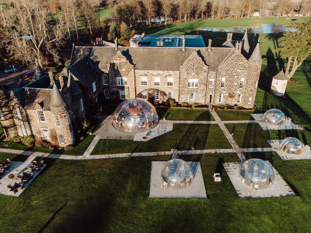 an aerial view of a house with domes in the yard at Meldrum House Hotel Golf And Country Estate in Oldmeldrum