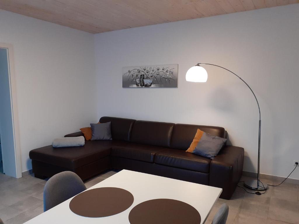 a living room with a couch and a table at Erdgeschoss-Appartement mit Seeblick in Ahrensbök