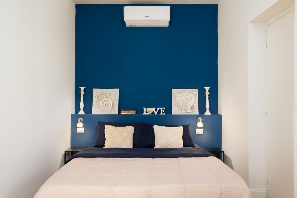 a bedroom with a blue wall and a bed at Affittacamere Z&I in Florence