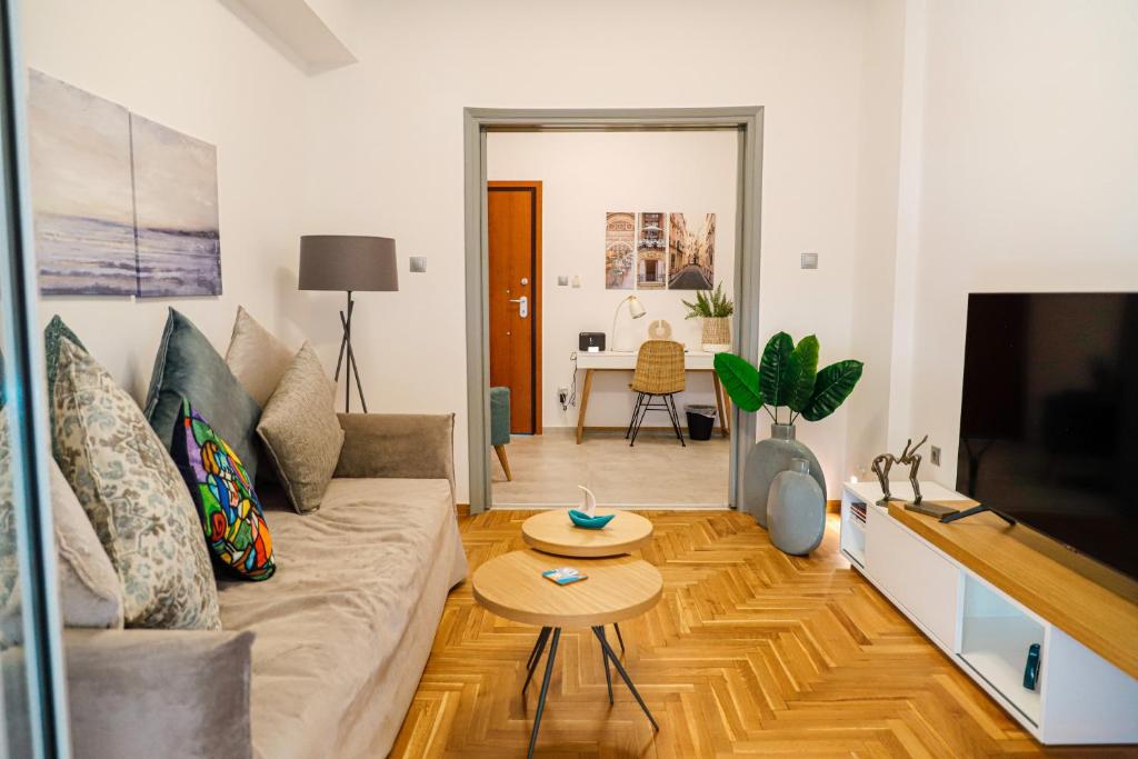 a living room with a couch and a tv at Newly Renovated Apartment 7 min walk from Acropolis in Athens