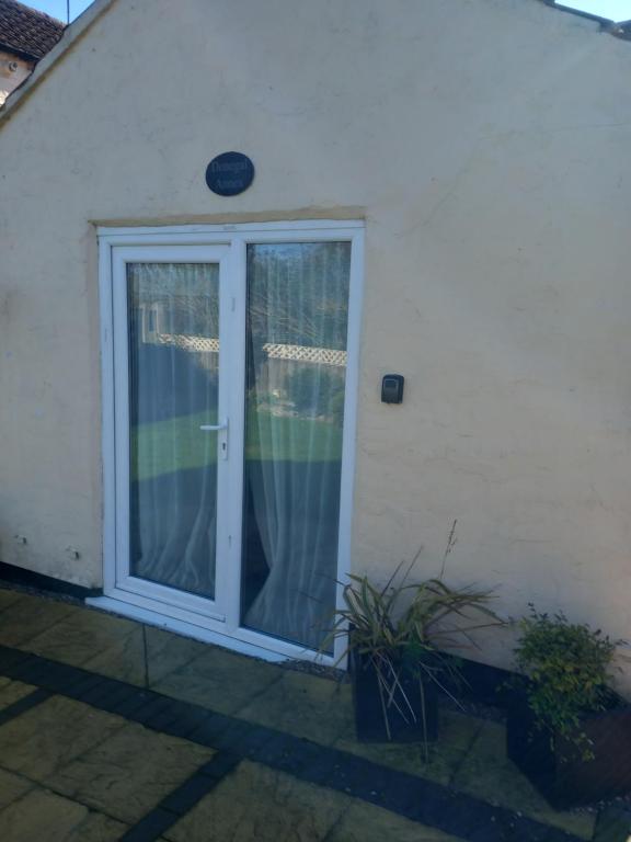 a sliding glass door with a window on a house at Saracens Head The Annex in Skegness