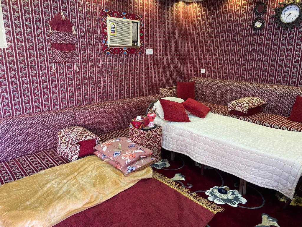 two beds in a room with purple wallpaper at Modernistic Antique Stay in Jeddah