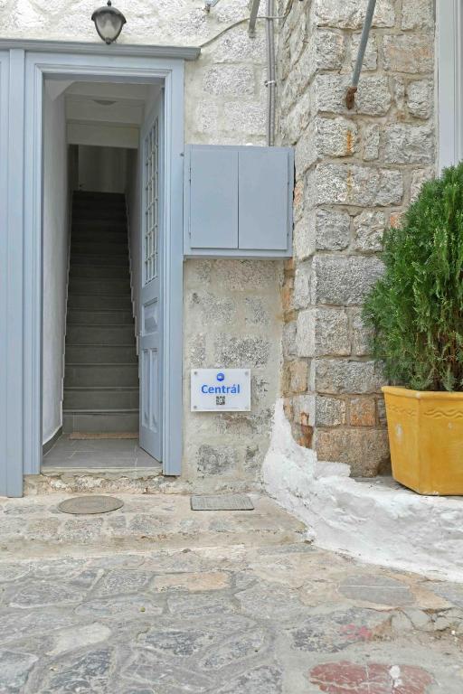 a entrance to a building with a sign on it at Centrál in Hydra