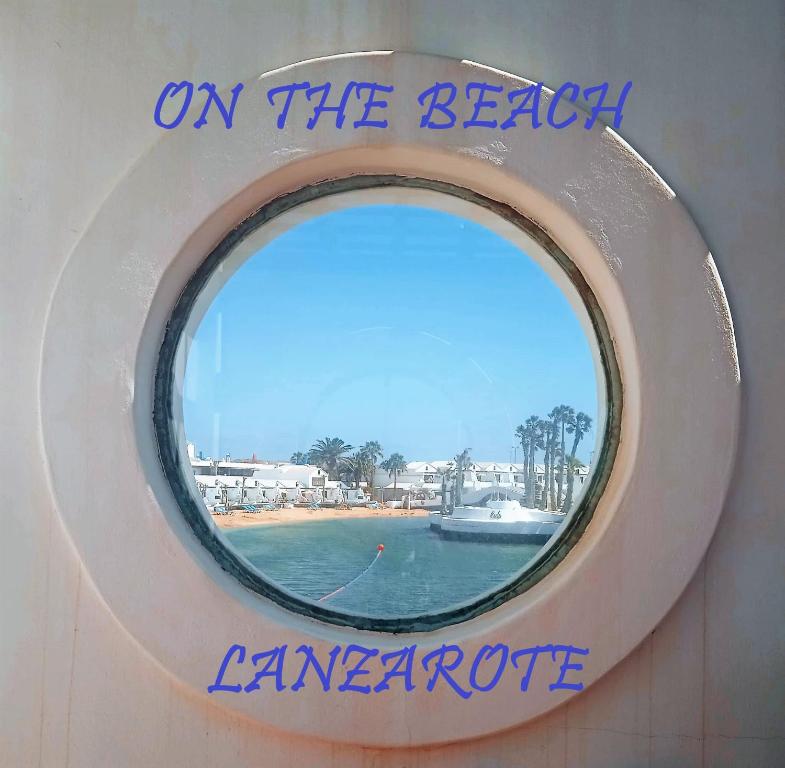 a round window on the side of a boat at ON THE BEACH in Costa Teguise