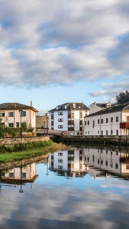a city with buildings and a river with buildings at Hotel La Bilbaina de Vegadeo in Vegadeo