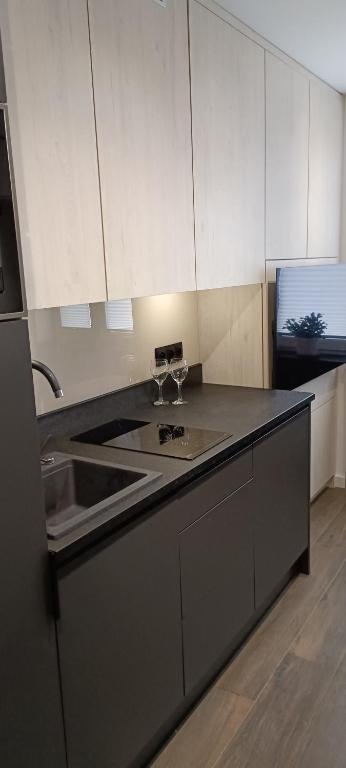 a kitchen with a sink and a counter top at Apartament 3 Maj 5 in Gorlice
