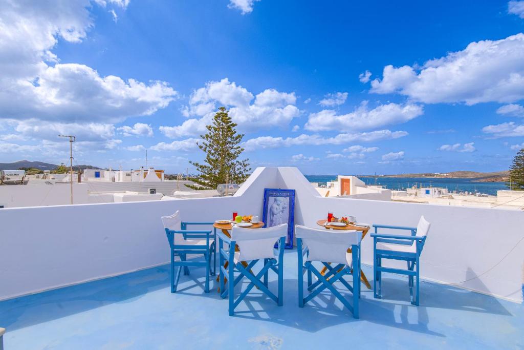 a table and chairs on the roof of a house at Porto Bello di Paros in Parikia