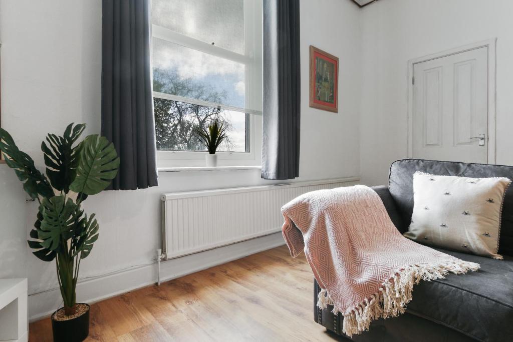 a living room with a couch and a window at Convenient 2-Bed Apartment - Ideal for Contractors & Working Away, Free Parking, Pet Friendly, Netflix in Sheffield