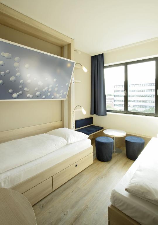 Postel nebo postele na pokoji v ubytování H2 Hotel Berlin-Alexanderplatz