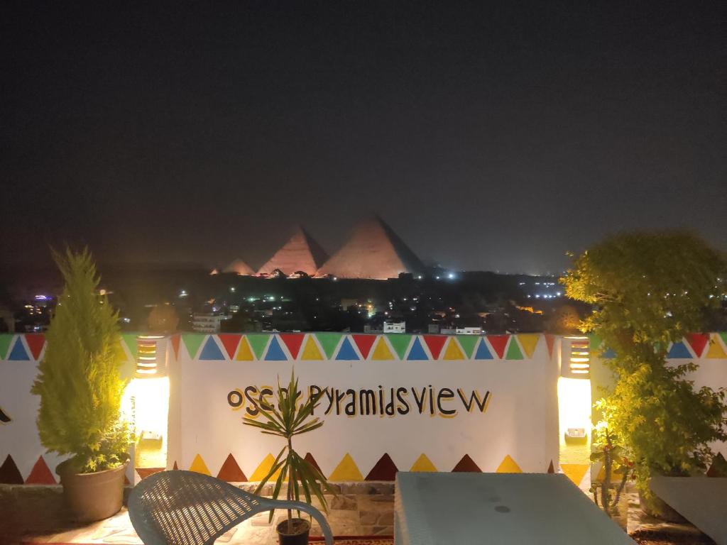 a view of the pyramids of giza at night at Oscar pyramids view in Cairo