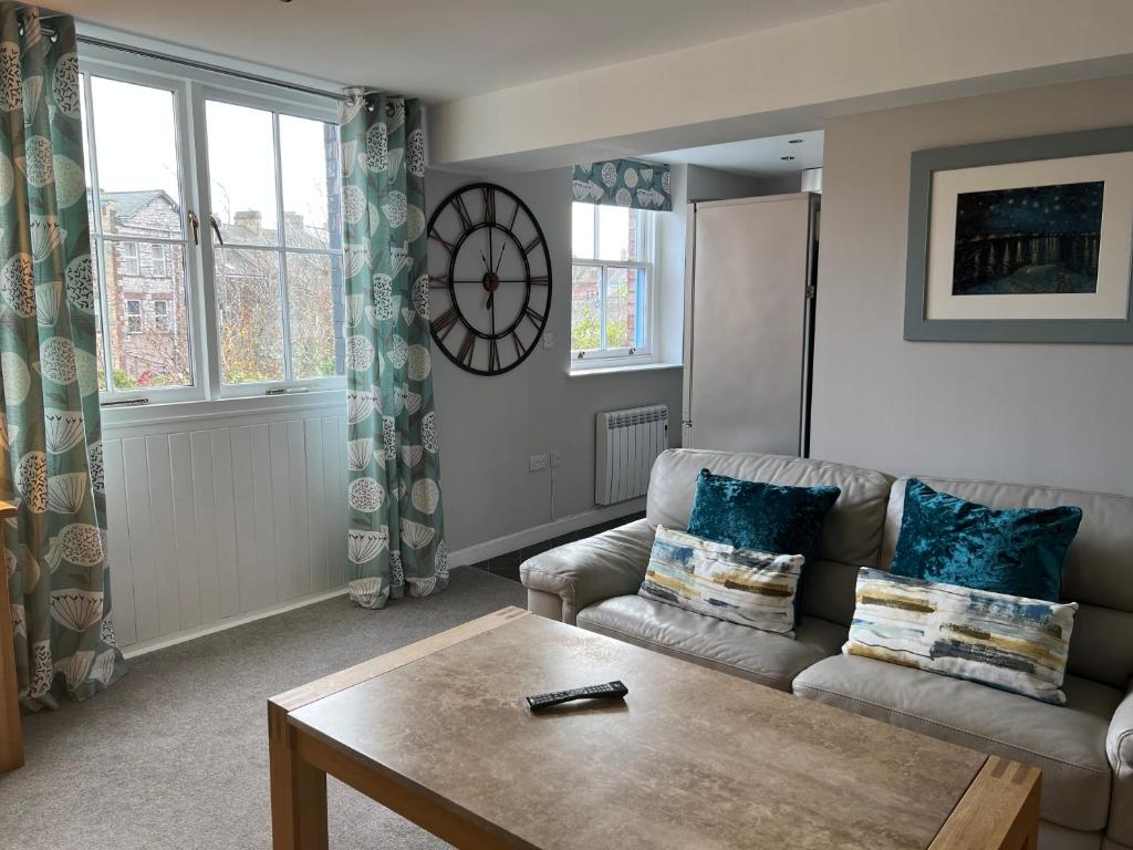 a living room with a couch and a table at Impeccable 1-Bed Apartment in Ulverston in Ulverston