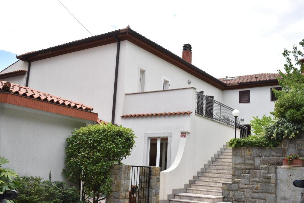 a white house with stairs in front of it at Apartment Angela in Portorož