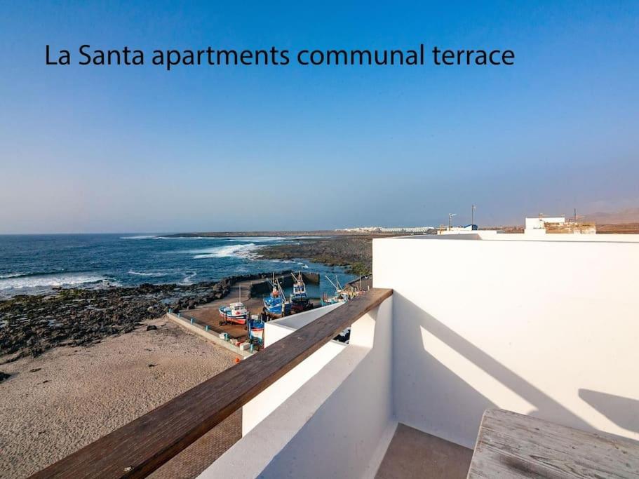 a balcony with a view of the beach and the ocean at Weybeach2 -shared terrace,plaza view,sea frontline in La Santa