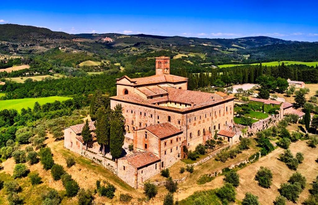 an aerial view of a large building on a hill at Fattoria Monastero Sant'Anna in Camprena in Pienza