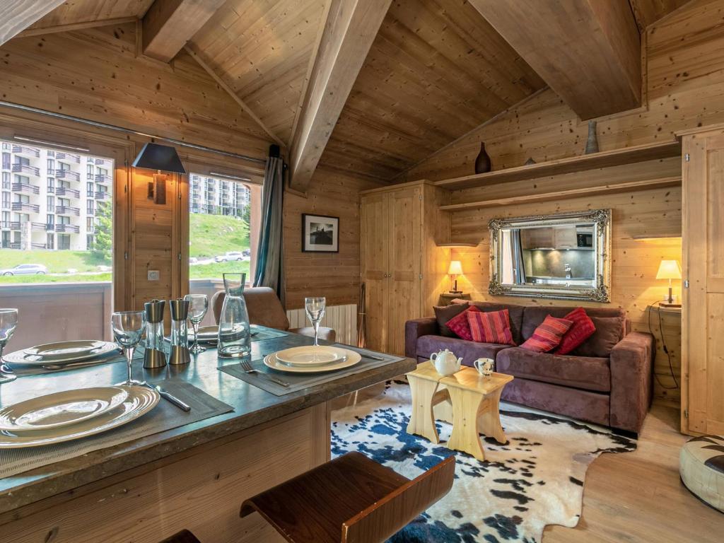 a living room with a couch and a table at Studio de standing avec balcon au cœur du village, proche pistes et commodités - FR-1-694-85 in Val dʼIsère