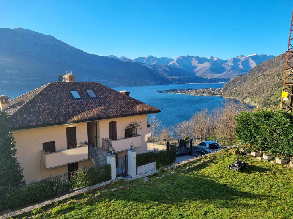 a house with a view of a lake at Apartment with garden and terrace beautiful lake view in Bellano