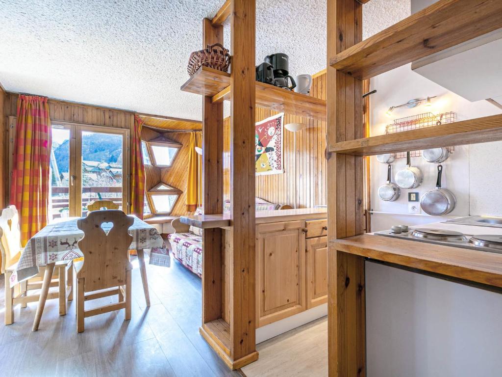 a kitchen with wooden cabinets and a table and chairs at Appartement Val-d'Isère, 2 pièces, 6 personnes - FR-1-694-227 in Val-d'Isère