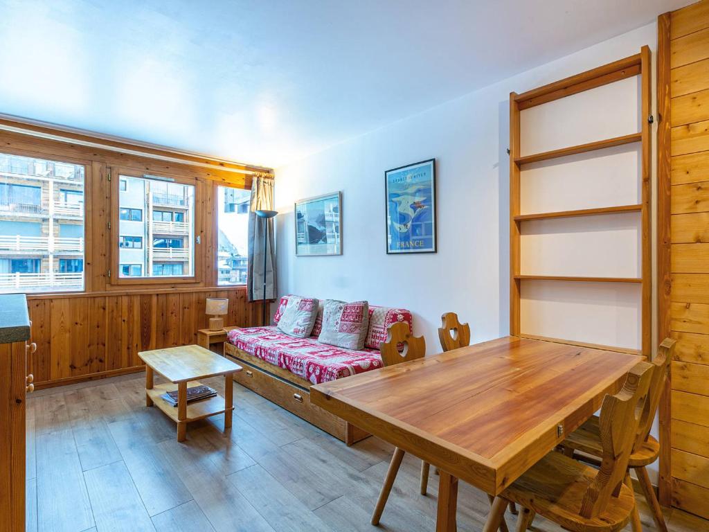 a living room with a couch and a wooden table at Appartement Val-d'Isère, 2 pièces, 4 personnes - FR-1-694-234 in Val-d'Isère