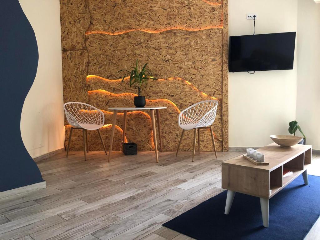 a living room with a table and chairs and a wall at Gallery House in Drama in Drama