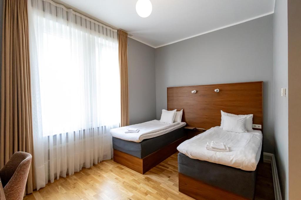 Postel nebo postele na pokoji v ubytování Hotell Hjalmar