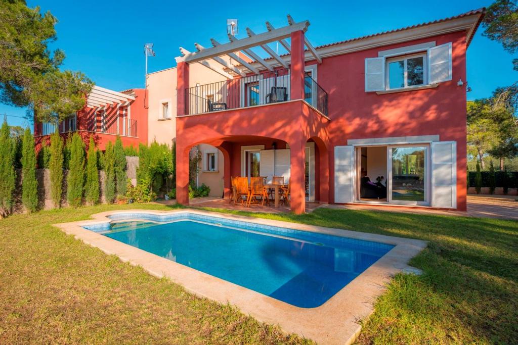 a house with a swimming pool in the yard at Villa Cala Pi in Cala Pi