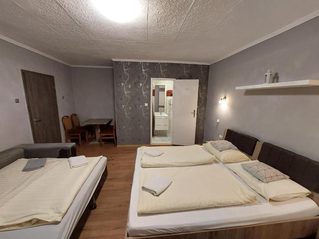 Postel nebo postele na pokoji v ubytování Oázis Vendégház és Appartman