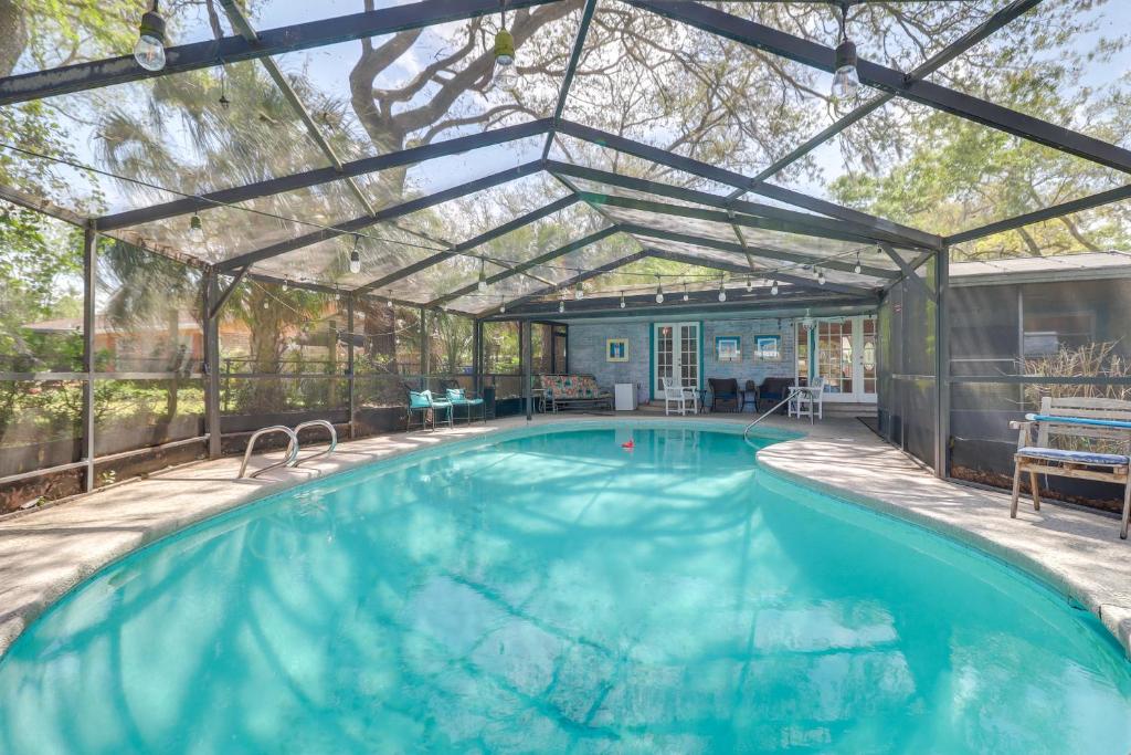 a swimming pool with a pergola and an indoor swimming poolvisor at Beach Retreat in Jacksonville Pet and Family-Friendly in Jacksonville Beach