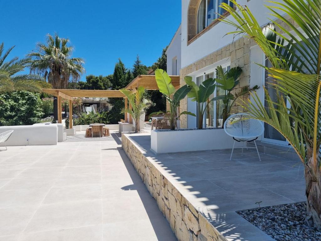 a patio of a house with a table and a chair at Casa El Sueño in Jávea