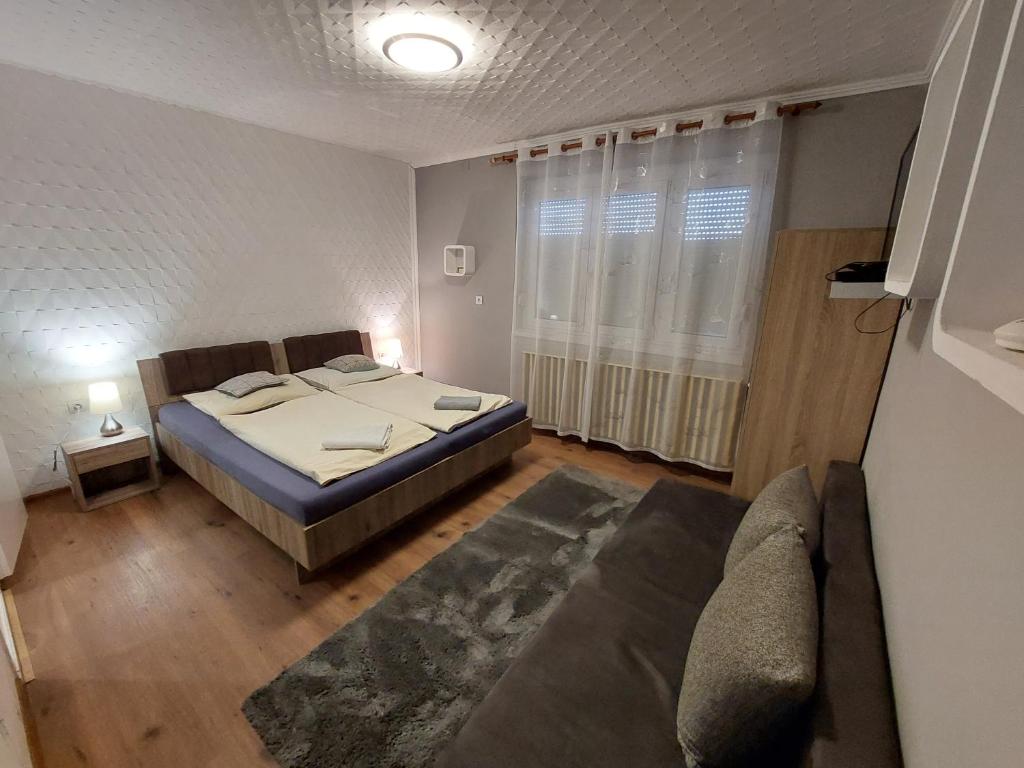 Postel nebo postele na pokoji v ubytování Oázis Vendégház és Appartman